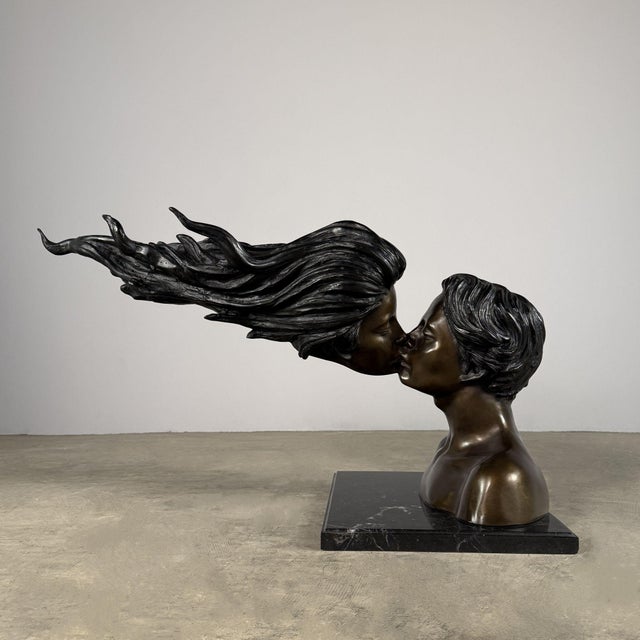 Striking large-scale bronze sculpture depicting two lovers locked in an intimate kiss, rendered in an elegant contemporary...