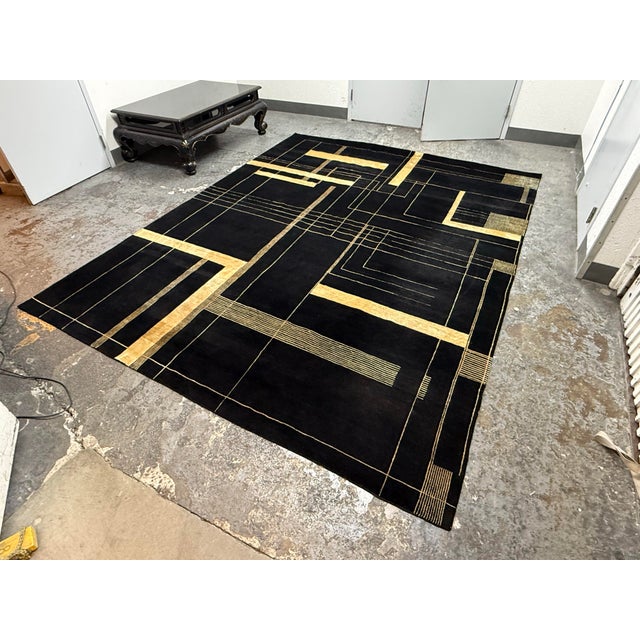 Design Plus Gallery presents a 9ft 1in × 11ft 10in Stark Carpet Area Rug. The rug is hand-knotted and showcases a black...