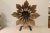 A carved wooden flower sculpture of assembled carved pieces of wood mounted on an iron stand. Very good Condition with...