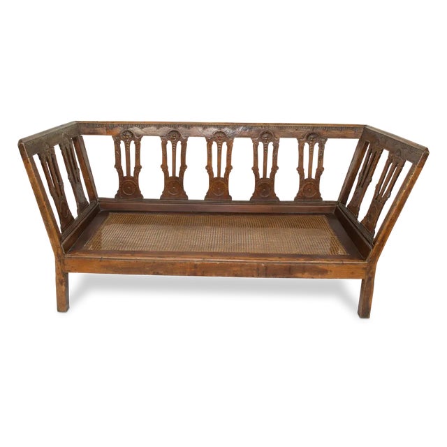 Beautifully carved antique European daybed with cane seat. The simple elegant design makes this piece timeless. It could...