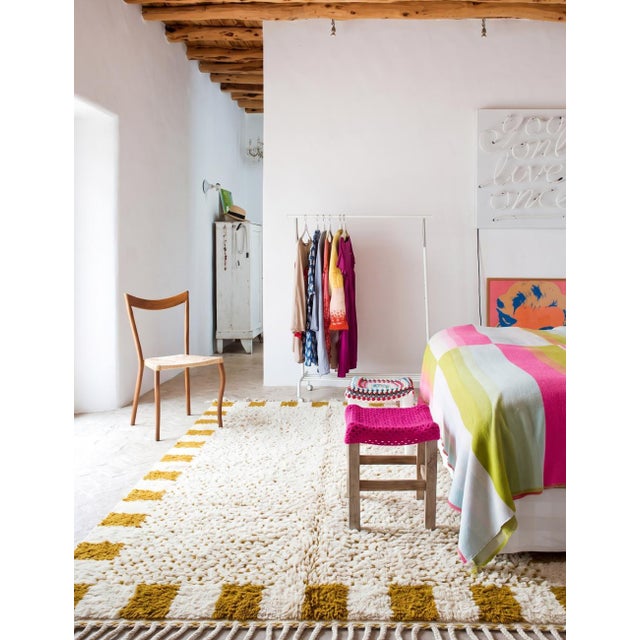 Polka Dots Boujad Rug | Handwoven Wool Rug with Speckled Field & Checkered Border This modern Boujad rug centers on a...