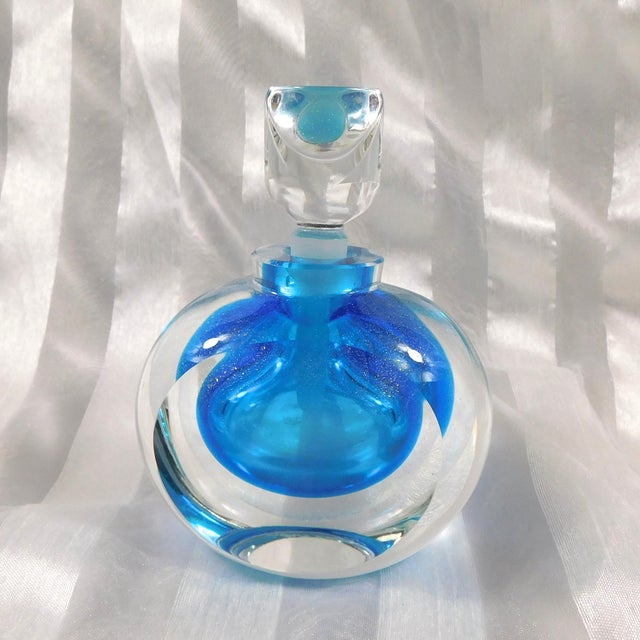 This is a Steven Correia turquoise blue art glass perfume bottle cased in clear glass with a slight gold glitter and the...