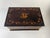 Charming antique wooden box with floral garland scroll inlay, urns at corners and initial inlays atop. 5 1/4" H x 11 1/2"...