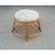 Rattan pouf stool with a medium finish and a cushioned seat upholstered in neutral colored upholstery. This vintage rattan...