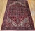 "A room-size Persian Heriz rug from the third quarter of the 20th century featuring a rich brick-red field elegantly...