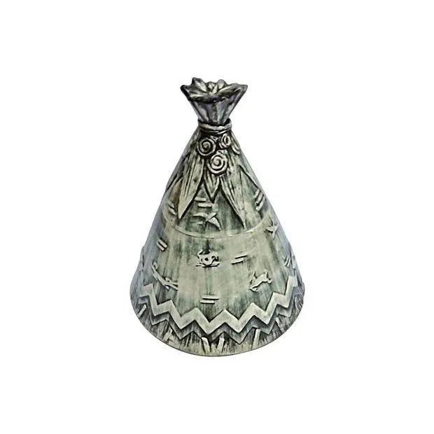 A vintage 1910-1950 Art Deco McCoy Native American teepee cookie jar with lid. The cookie jar features a teepee shaped...