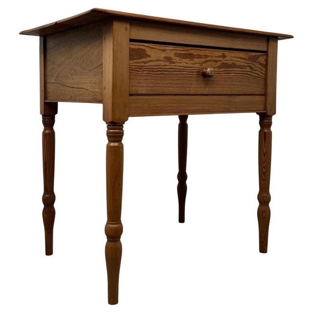 A handsome 19th-century English Victorian side table, finely crafted from pitch pine and distinguished by its beautifully...