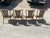 Elegant set of four cherrywood caned back dining chairs with brass sabots and brass crest rail. All of the metal pieces...