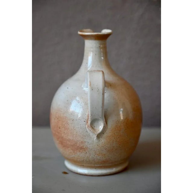 This beautifully worked ceramic pitcher is stamped with the pottery sandstones of the marsh. Its collar is nicely open and...