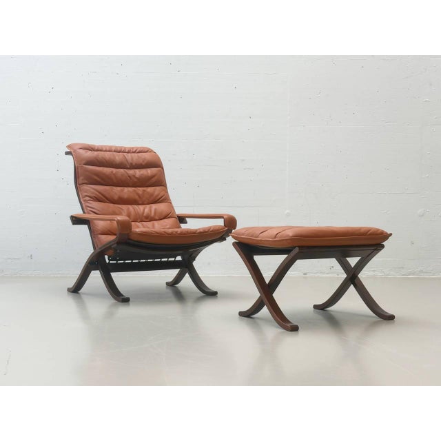Iconic scandinavian lounge chair with matching footstool, designed by ingmar relling for the norwegian manufacturer...