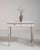 A delicate Louis XVI table featuring a white patinated finish that enhances its decorative appeal. The straight lines and...