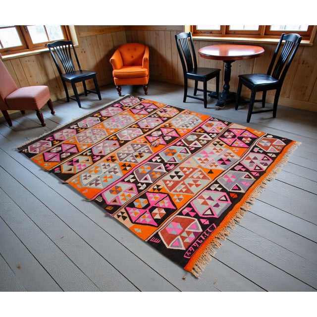 This exceptionally vibrant flat-weave kilim hails from the Kars region of Eastern Anatolia, dated specifically to 1966 as...