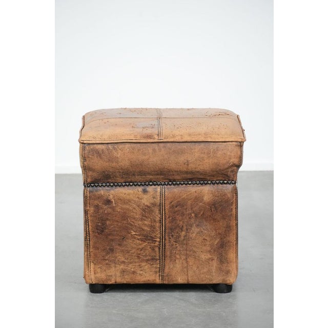 We offer this sturdy square vintage sheepskin pouf/footstool in beautiful colors. A sheepskin footstool, also known as a...