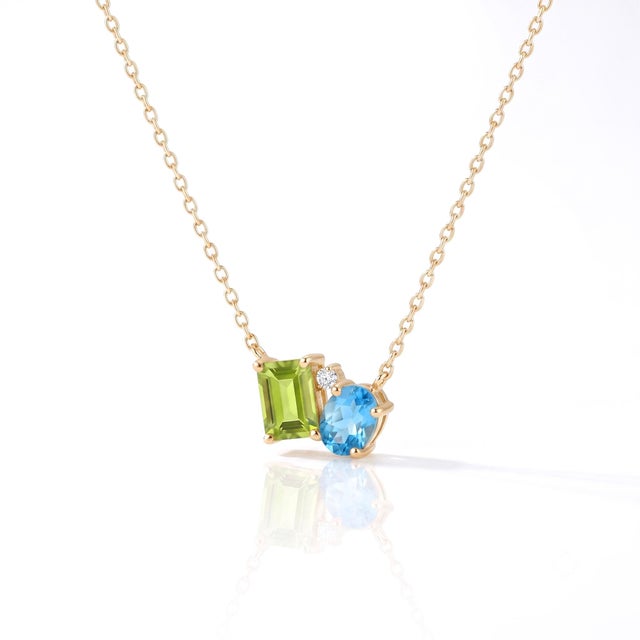 Cool Symmetry in Motion: Peridot and Swiss Blue Topaz asymmetrical Pendant with Diamond Accents Make a fresh and modern...