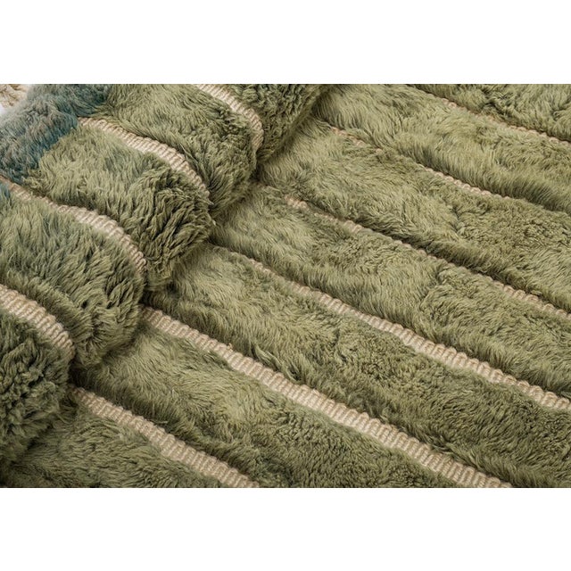 Fine ivory pinstripes trace down a richly mottled olive and sage field, giving this rug the plush, natural texture of...