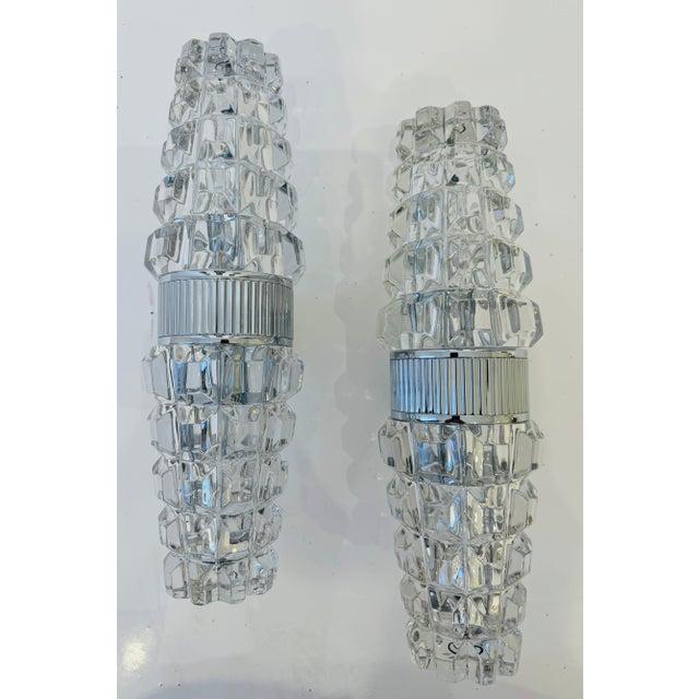 A pair of luxurious 1970s French Space Age chrome wall lamps with thick heavy crystal faced shades by the French firm,...