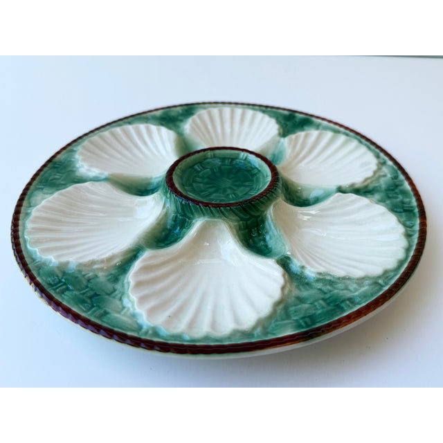 A beautiful antique French Faïence Longchamp majolica oyster plate featuring a rich emerald green basket weave glaze...