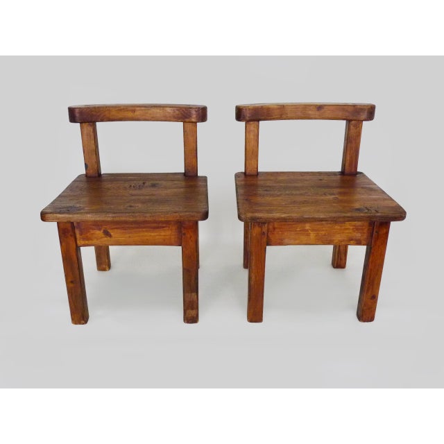 Pair of Brutalist Low Chairs in Solid Wood. 1960s A beautiful pair of vintage Brutalist wooden chairs. Their rustic,...