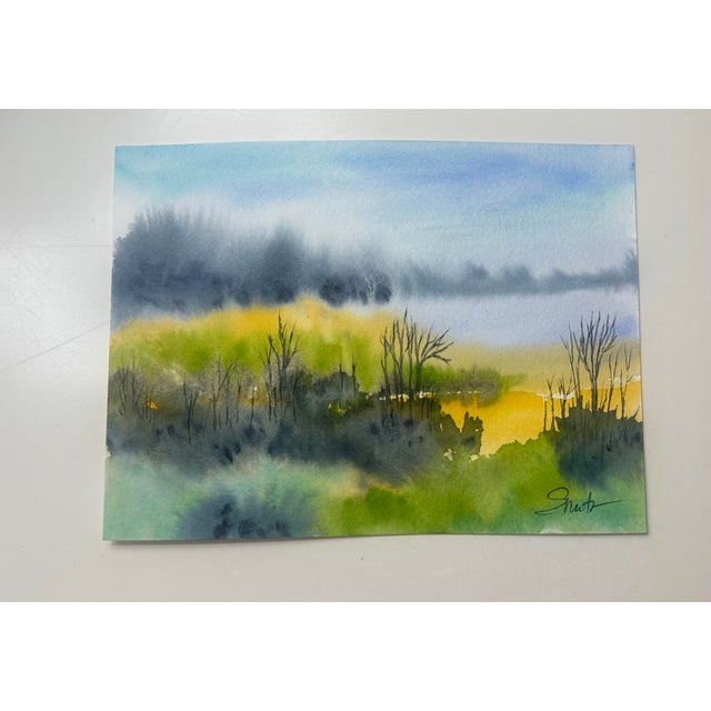A luminous watercolor landscape capturing the quiet beauty of wetlands at dusk. Soft washes of golden yellow and fresh...