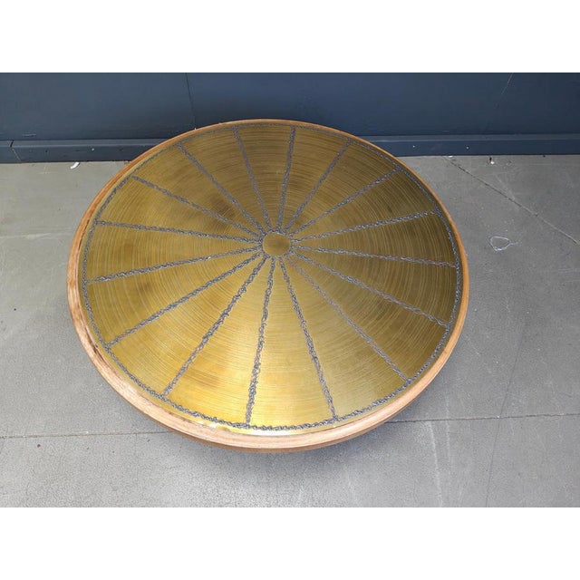 Round wooden coffee table with an etched brass top. Artistic table top with contrasting welding and etched brass pattern....