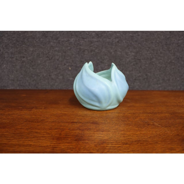 Van Briggle art pottery vase featuring a sculptural, petal-like form with sweeping raised relief and a soft blue-green...