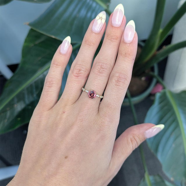 A striking 2.3ct red zircon set in solid 14K gold, radiating rich, fiery brilliance. Accented with earth-mined diamonds...