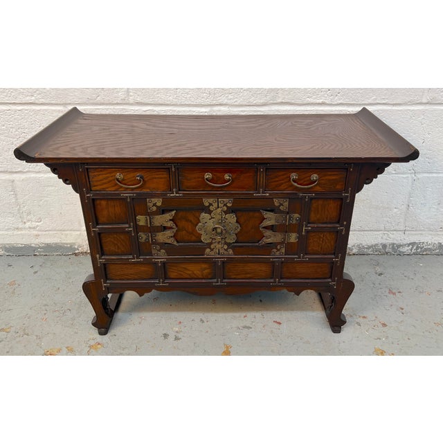 Distinctive antique-style Korean tansu cabinet featuring traditional butterfly hardware and richly detailed craftsmanship...