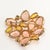 Gorgeous brooch featuring peachy pink unfoiled glass stones Schiaparelli collectors adore along with yellow accents....