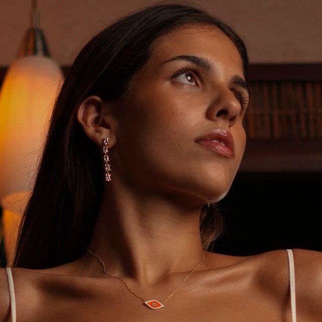 Illuminate your look with the Elegant Drop Down Diamonds Earrings , featuring elegant 24k gold-plated frames that house...