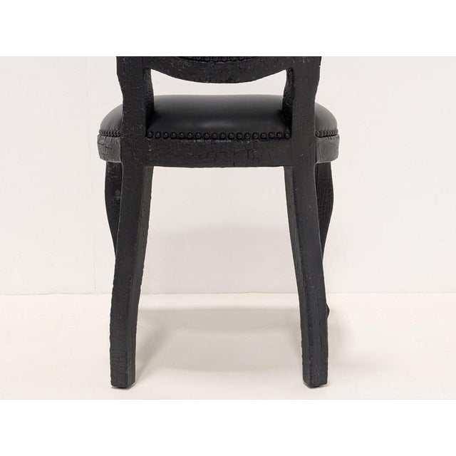 The Smoke dining chair by moooi is dark and mysterious, but also beautiful thanks to its burned wood finish which is...