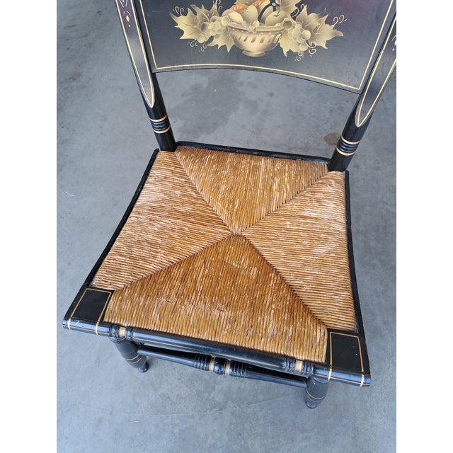 Wonderful old reproduction of an Early American chair with woven rush seat. The black paint has scrapes mostly around the...