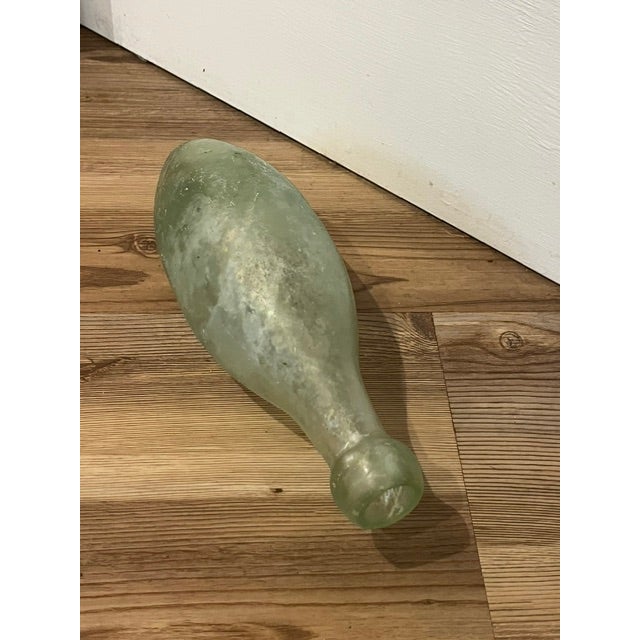 Antique torpedo soda bottle (also known as a Hamilton bottle) from the mid-to-late 1800s, crafted from aqua-green blown...