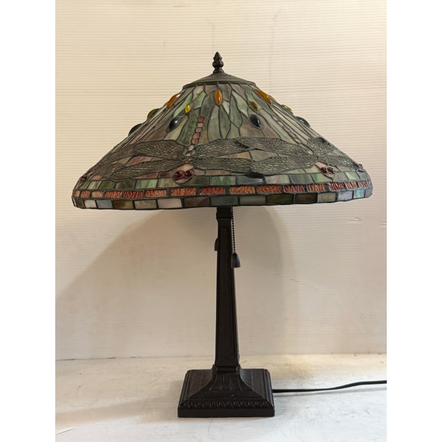 This 20th century Tiffany-style table lamp is a wonderful example of the Art Nouveau style. Accompanied by a beautiful...