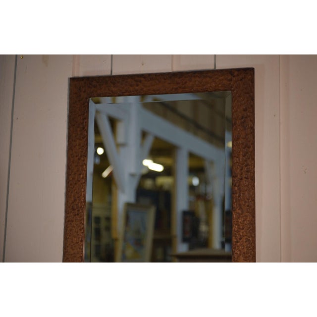 A unique piece with a highly sculptural character, this 1960s mirror combines a hand-carved solid oak frame with a beveled...