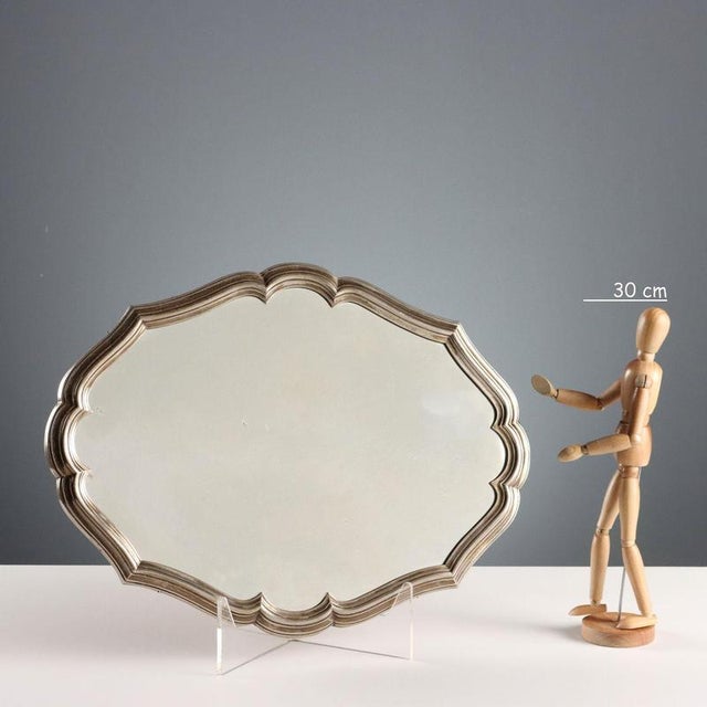 Mirrored tray on a wooden base. The wavy edge is embossed with silver. Silver hallmarks are engraved on the edge. This...