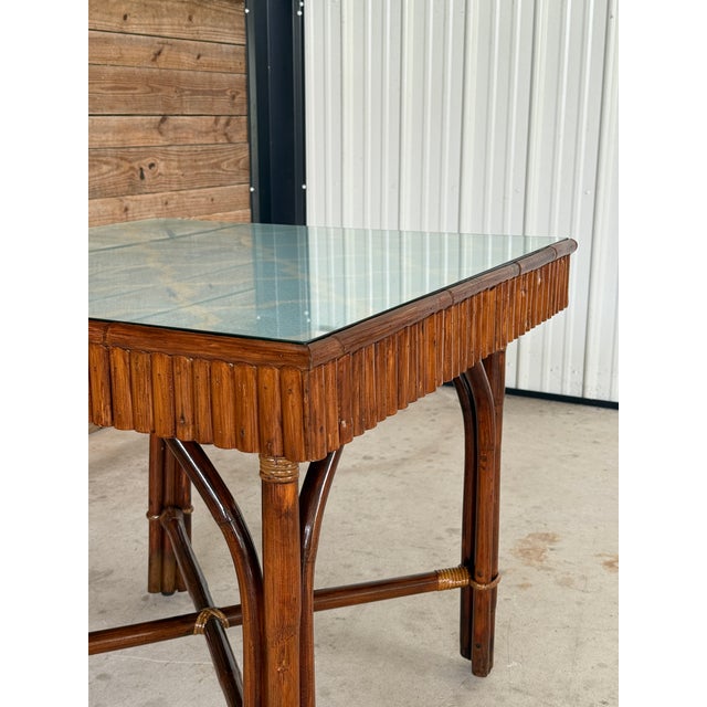 A one-of-a-kind, custom-designed game table featuring a vintage Ficks Reed split rattan base paired with a newly crafted...