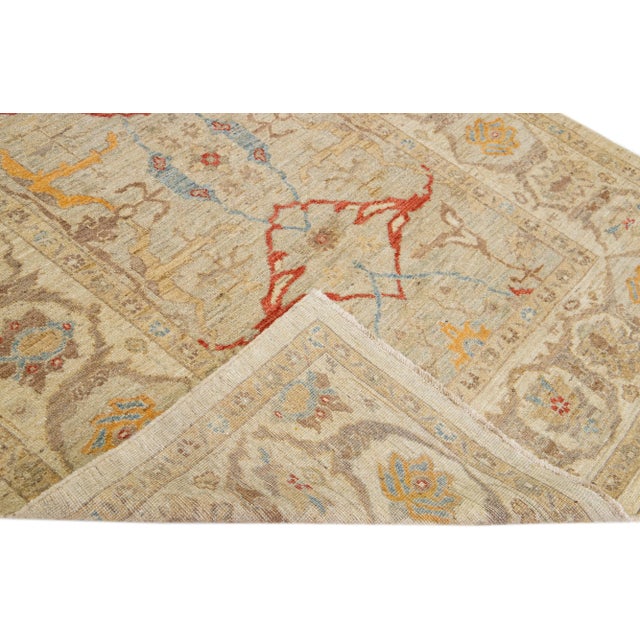 Beautiful modern Sultanabad hand-knotted wool rug with a beige color field. This rug has a designed frame with red,...