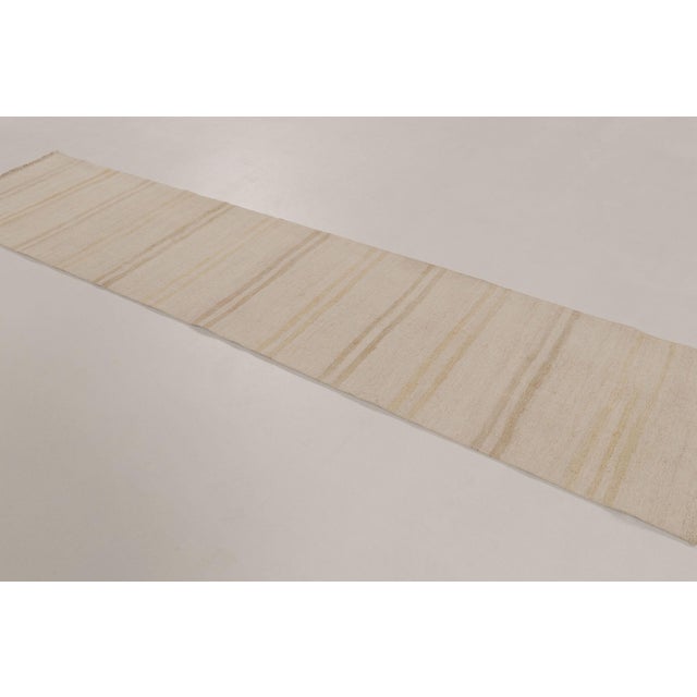 Handwoven in hemp circa, this 2x11 modern runner rug presents a refined, minimalist interpretation of traditional textile...