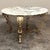 An elegant Italian coffee table combines a hand-forged iron base with its original richly figured round marble top....