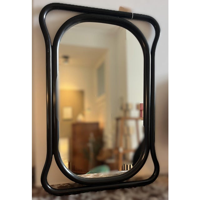 Vintage mirror with a playful black wooden frame. 54 wide x 79 high.