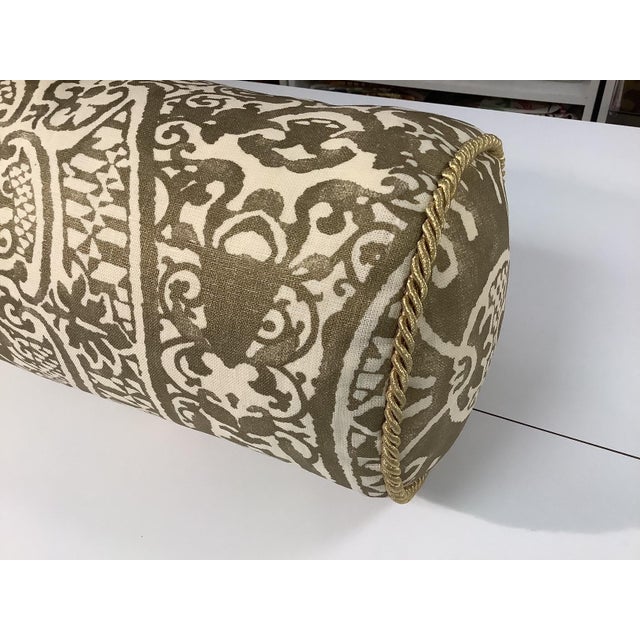 Gold and cream bolster pillow in Quadrille fabric with down insert and gold cording.