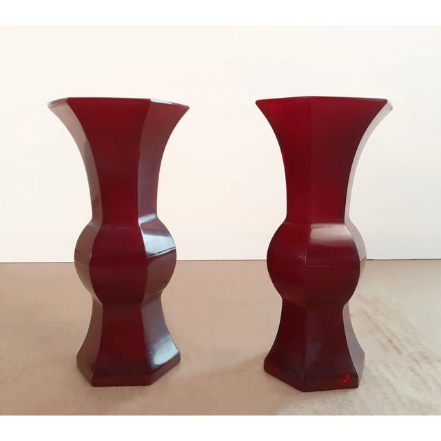 A pair of Chinese, ruby red, Peking glass gu , a finely formed, matched pair of beaker shape vases with a deep,...