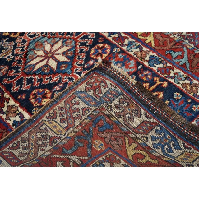 This nearly shaggy pile southwest Persian nomadic scatter presents a navy field with four charmingly irregular hooked...
