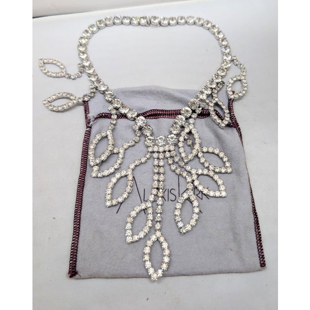 1980s rhodium plated prong set round clear rhinestones in the shape of pointed ellipse drops bib necklace with box clasp....