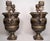 A Pair of Circa 1850 Pompeian Neoclassical Patinated Bronze Urns. These beautiful urns have boar's head handles surmounted...