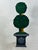 This whimsical umbrella stand is painted wood. Sturdy and functional with a fun touch!