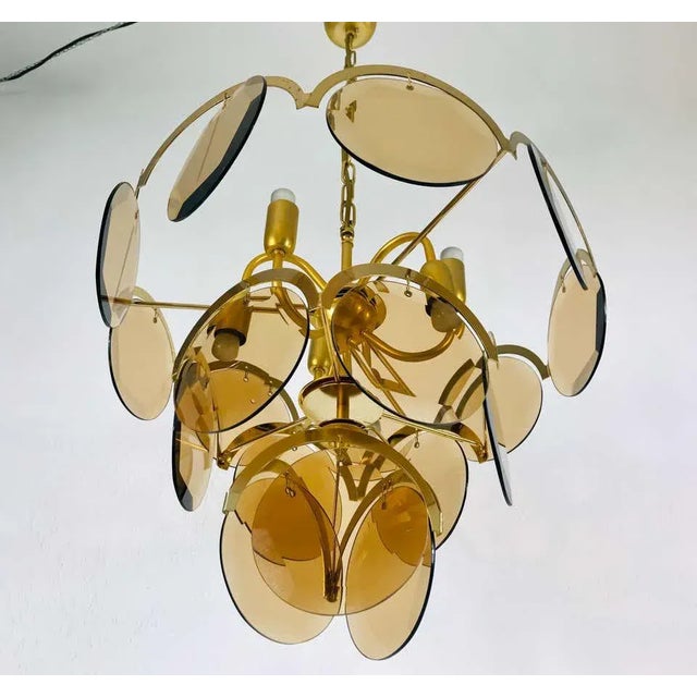 A midcentury chandelier made in Italy in the 1960s. It is fascinating with its colorful glasses and chrome body. The light...