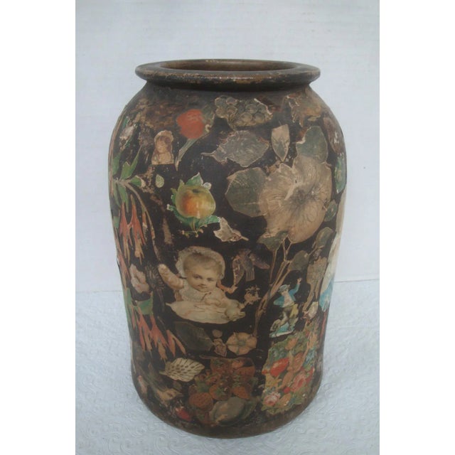 Incredible antique hand-thrown earthenware clay vessel that was profusely decorated with paper cutouts which look to be...