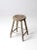 This is an antique primitive wood stool. The classic farmhouse stool features a round seat with remnants of white paint...