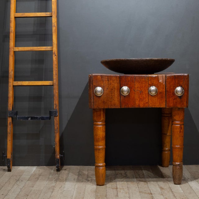 ABOUT An antique solid Maple butcher's block with a 10 inch thick top, original metal caps, turned legs and a food safe,...